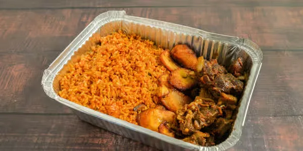 Jollof rice served with spicy asun goat meat in Winnipeg